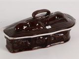 a brown and white ceramic box on a white surface