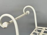 a white metal chair with a metal seat and back
