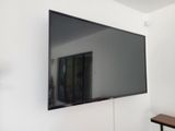 a flat screen tv mounted on the wall in a room