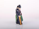 a figurine of a man with a hat and a robe