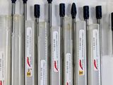 six glass vials of different sizes and sizes are lined up on a white surface