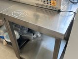 stainless steel counter top with a machine on top of it in a kitchen