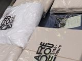 boxes of clothing are stacked on top of each other in a store