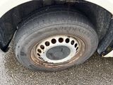 a dirty tire on the side of a white car