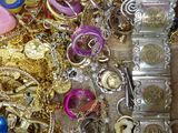 a wooden box filled with lots of gold and silver jewelry