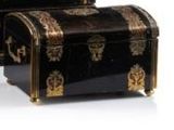 two black and gold boxes with gold decorations on them on a white surface