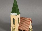 a small building with a green steeple on top of it