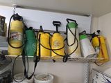 many buckets of paint on a shelf in a room