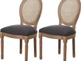 paire de chaises de salle à manger à dossier en rotin avec coussins rembourrés noirs