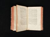 an open book on a black surface with a black background