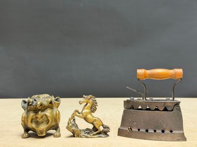 two small figurines sitting on a table next to each other