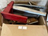 a box full of tools sitting on a wooden floor
