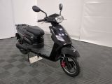 a black scooter parked in a room with a checkered floor