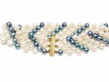 a close up of a bracelet with pearls and a gold clasp