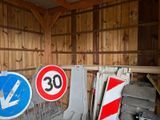 many signs in a garage that are leaning against the wall