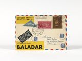 une vieille carte postale sur laquelle sont collés de nombreux timbres, sur un fond blanc