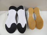 two pairs of black and white shoes sitting next to each other