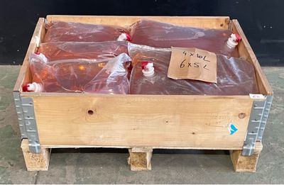 une boîte en bois remplie d'un liquide rouge et de sacs en plastique