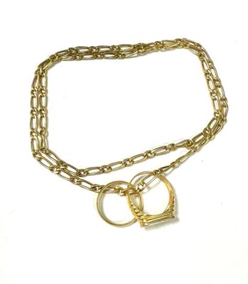 a close up of a gold chain with two rings on it