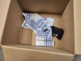 a cardboard box with a bunch of towels inside of it