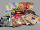 many children ' s books that are on the table