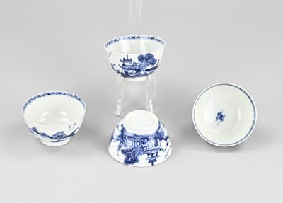 three pieces of blue and white porcelain on a white surface