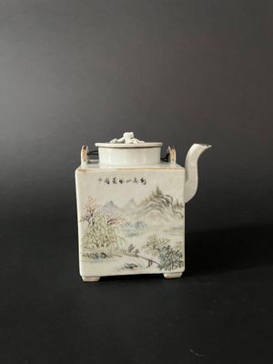 an image of a white tea pot sitting on top of a table