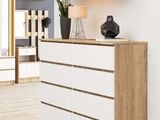 a picture of a white and wood dresser in a living room
