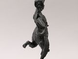 a black statue of a man with a horned head and horns on his head