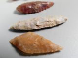 several different types of arrowheads are displayed on a table