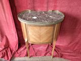 une petite table avec un plateau en marbre