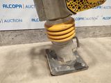 a close up of a metal object with a yellow object attached to it