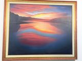 painting hanging on the wall of a room with a painting of a sunset