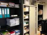 a room with a lot of files on the shelves