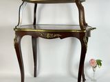 a small table with a glass shelf on top of it