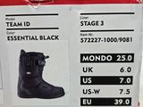 a box with a pair of black snow boots in it