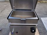 an image of a stainless steel fryer sitting on top of a wooden pallet