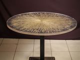 a close up of a table on a tiled floor with a purple background