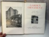someone holding a book open to a picture of a garden ornament