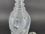 an old fashioned glass bottle with a stopper on a black background