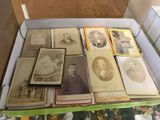 a lot of old photos in a box on the table