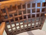 a wooden chair with a striped seat and back cushion