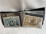 two old stamps are sitting on top of each other on a table