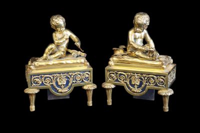 pair of antique brass figurines of a boy and a girl sitting on a bench