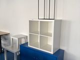a blue cabinet and a white table in a room