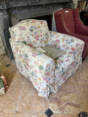 a chair that is sitting in front of a fire place