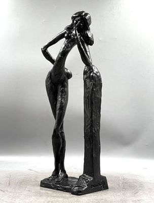 black and white photograph of a statue of a woman standing on a rock