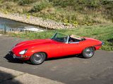 an image of a red sports car parked on the side of the road