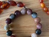 two bracelets that are sitting on a table