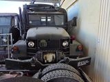 two trucks that are parked next to each other in a garage